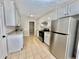 Modern kitchen featuring stainless steel appliances, white cabinets, and tile flooring at 134 Carrollwood Dr, Fayetteville, GA 30215