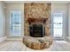 Living room featuring stone fireplace and ample natural light at 134 Carrollwood Dr, Fayetteville, GA 30215