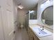 Bright bathroom featuring a glass shower, vanity, and an oval mirror with decorative lighting at 300 Johnson Ferry Rd # B105, Atlanta, GA 30328