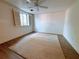 Spacious bedroom with a large window, ceiling fan, neutral carpet, and laminate flooring at 300 Johnson Ferry Rd # B105, Atlanta, GA 30328