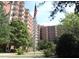 Exterior shot of a brick apartment building with balconies and an American flag at 300 Johnson Ferry Rd # B105, Atlanta, GA 30328