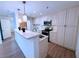 Well-lit kitchen featuring white cabinets, stainless steel appliances, and a convenient breakfast bar at 300 Johnson Ferry Rd # B105, Atlanta, GA 30328