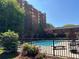 Outdoor pool and deck with lounge chairs and views of the surrounding complex and trees at 300 Johnson Ferry Rd # B105, Atlanta, GA 30328