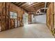 Unfinished basement with window, door, exposed beams, and insulation ready to be completed to buyer's preference at 4716 Alpine Sw Dr, Lilburn, GA 30047