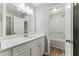 Bathroom with a white quartz countertop, modern lighting, and a shower/tub combination at 4716 Alpine Sw Dr, Lilburn, GA 30047