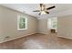 Bedroom offering comfort with plush carpeting, a ceiling fan, and a dedicated study area with lots of natural light at 4716 Alpine Sw Dr, Lilburn, GA 30047