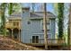 Back exterior view of home with multiple decks, siding, and wooded lot; a great outdoor retreat at 4716 Alpine Sw Dr, Lilburn, GA 30047