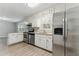 Functional kitchen featuring stainless steel appliances, white cabinets, granite countertops, and hardwood floors at 4716 Alpine Sw Dr, Lilburn, GA 30047