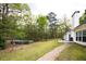 Serene backyard featuring a brick path, above ground pool, and mature trees for ultimate privacy at 794 Lucas Dr, Hampton, GA 30228