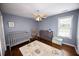 Cozy Bedroom with a crib, changing table, and a rocking chair, perfect for a new baby at 794 Lucas Dr, Hampton, GA 30228