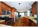 Well-equipped kitchen with stainless steel appliances, granite countertops, and wood cabinets overlooking the dining area at 794 Lucas Dr, Hampton, GA 30228