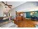 Open-concept living room featuring vaulted ceilings, a ceiling fan, and hardwood floors throughout the kitchen and dining area at 794 Lucas Dr, Hampton, GA 30228