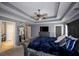 Spacious main bedroom features tray ceilings, an integrated ceiling fan, a large bed, and carpet flooring at 794 Lucas Dr, Hampton, GA 30228