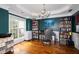 Inviting home office with beautiful hardwood floors, custom bookshelves, and ample natural light at 794 Lucas Dr, Hampton, GA 30228