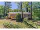 Home featuring a wooden deck and a serene wooded backyard at 842 Brighton Dr, Lawrenceville, GA 30043