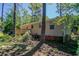 Backyard view of a home with a deck, trees, and lush greenery at 842 Brighton Dr, Lawrenceville, GA 30043