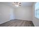 Bedroom featuring wood-look flooring, a window with blinds, and modern ceiling fan at 842 Brighton Dr, Lawrenceville, GA 30043