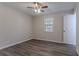 Bedroom featuring wood-look flooring, a window with blinds, and modern ceiling fan at 842 Brighton Dr, Lawrenceville, GA 30043