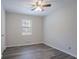 Bright bedroom featuring wood-look flooring, a window, and fresh neutral paint at 842 Brighton Dr, Lawrenceville, GA 30043