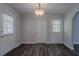 Neutral entryway featuring modern light fixture and two doors with natural light at 842 Brighton Dr, Lawrenceville, GA 30043