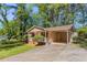 Single-story home boasts a covered carport and inviting front porch with lawn at 842 Brighton Dr, Lawrenceville, GA 30043
