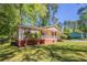 Side view of cozy single-story home with a front porch and well-maintained lawn at 842 Brighton Dr, Lawrenceville, GA 30043