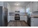 Modern kitchen boasts stainless steel appliances, white cabinets, and stylish backsplash at 842 Brighton Dr, Lawrenceville, GA 30043
