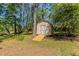 Outdoor shed with a ramp surrounded by mature trees and a lawn at 842 Brighton Dr, Lawrenceville, GA 30043