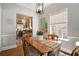 Cozy dining area with wood floors, a table with colorful runner, and a view leading into the adjacent kitchen at 937 E Rock Springs Ne Rd, Atlanta, GA 30306