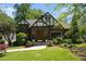 Charming Tudor-style home with a well-manicured lawn, beautiful landscaping, and classic architectural details at 937 E Rock Springs Ne Rd, Atlanta, GA 30306