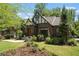 Charming Tudor-style home with a well-manicured lawn, beautiful landscaping, and classic architectural details at 937 E Rock Springs Ne Rd, Atlanta, GA 30306