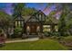 Charming Tudor-style home with a well-manicured lawn, beautiful landscaping, and classic architectural details at 937 E Rock Springs Ne Rd, Atlanta, GA 30306