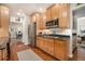 Galley kitchen featuring stainless steel appliances, wood cabinets, granite countertops, and hardwood floors at 937 E Rock Springs Ne Rd, Atlanta, GA 30306