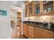 Kitchen with wooden cabinets, stainless steel sink, granite countertops, and a view into the dining room at 937 E Rock Springs Ne Rd, Atlanta, GA 30306