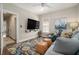 Comfortable living room with a large screen TV, ceiling fan, stylish rug, and comfortable seating at 937 E Rock Springs Ne Rd, Atlanta, GA 30306