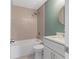 Bathroom featuring tub and shower, sleek vanity, gold fixtures and tile floors at 103 St Albans Way, Peachtree City, GA 30269