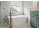 Bright bathroom showcases a soaking tub and double vanity with ample lighting at 103 St Albans Way, Peachtree City, GA 30269