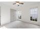Bright bedroom with neutral carpet, double closet doors, and two sunny windows at 103 St Albans Way, Peachtree City, GA 30269