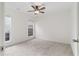 Bright bedroom boasts neutral carpet, two windows and white walls at 103 St Albans Way, Peachtree City, GA 30269