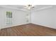 Spacious bedroom with hardwood floors, ceiling fan, and large windows offering natural light at 103 St Albans Way, Peachtree City, GA 30269