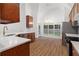 Bright kitchen with stainless appliances, hardwood floors, modern countertops, and a view to the backyard at 103 St Albans Way, Peachtree City, GA 30269