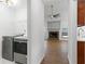 Modern laundry area leading to an open-concept living space with a fireplace at 103 St Albans Way, Peachtree City, GA 30269