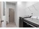 Laundry room featuring modern washer and dryer units and a door leading outside at 103 St Albans Way, Peachtree City, GA 30269