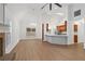 Bright living room with tall ceilings, hardwood floors, and an open floorplan to the kitchen at 103 St Albans Way, Peachtree City, GA 30269
