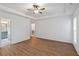 Primary bedroom boasts hardwood floors, a ceiling fan, and doors leading to the bathroom and closet at 103 St Albans Way, Peachtree City, GA 30269