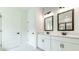 Stylish bathroom featuring double vanity with dark fixtures and white cabinets at 1518 Gatekeeper Ter, Marietta, GA 30066