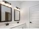 Bathroom features double sinks with dark fixtures and matching framed mirrors at 1518 Gatekeeper Ter, Marietta, GA 30066