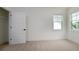 This carpeted bedroom features two windows for plenty of natural light and a walk-in closet at 1518 Gatekeeper Ter, Marietta, GA 30066