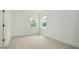 Bedroom with two bright windows, neutral carpet, and white trim at 1518 Gatekeeper Ter, Marietta, GA 30066