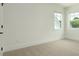 This neutral carpeted bedroom has two windows and a white trim at 1518 Gatekeeper Ter, Marietta, GA 30066